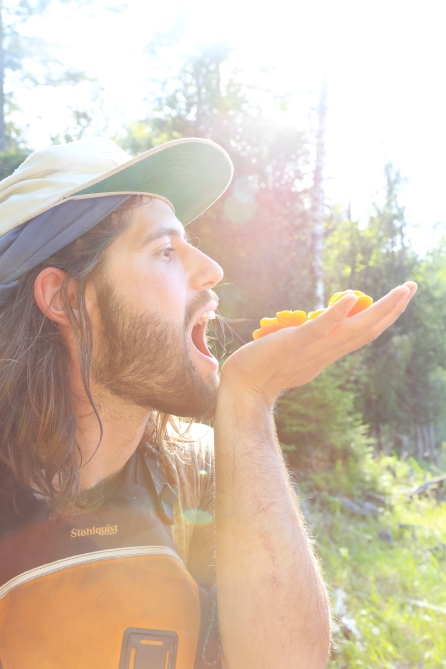 Just as it is with anthropological photography, professional photography necessitates good rapport with the people, practices and places being photographed. In this image a former expedition guide creatively poses for a photo that expresses the fun and excitement of snacking on well-earned dried apricots with friends at the end of a big leg of portages.